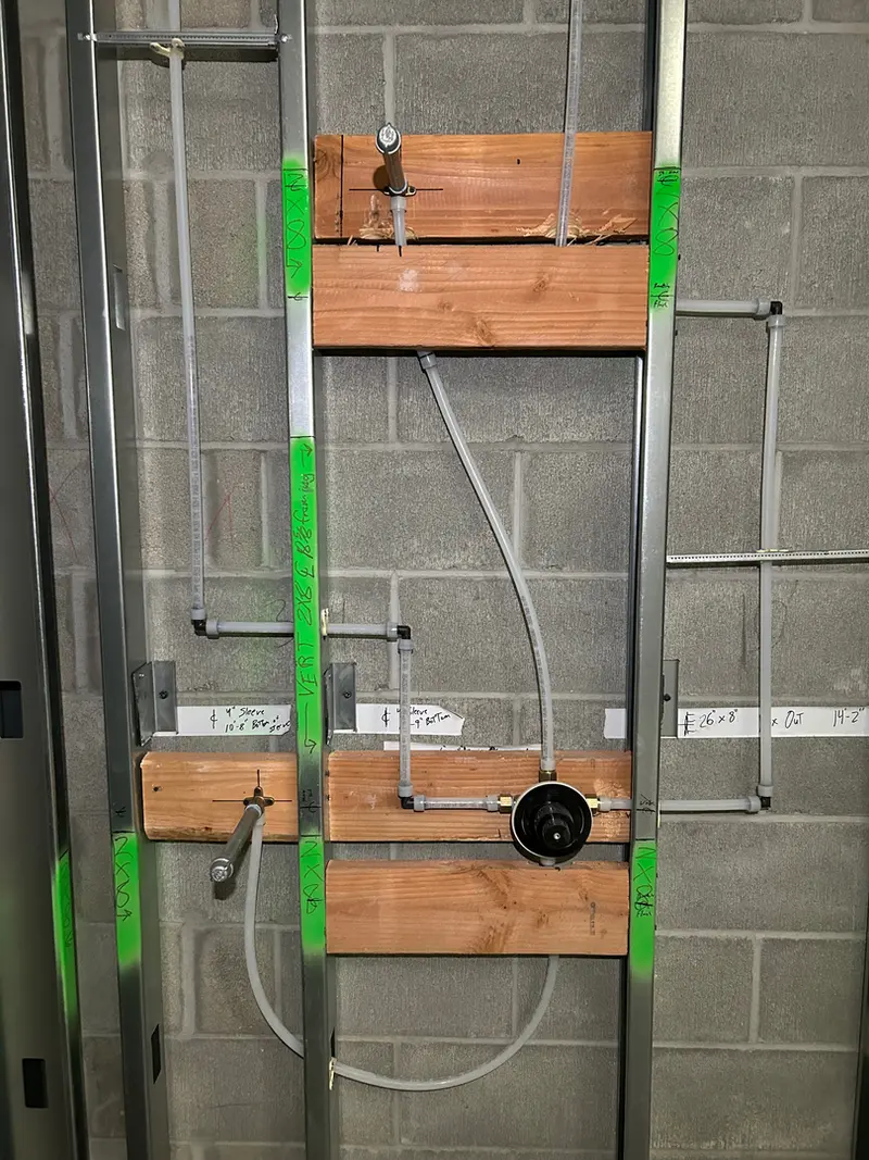 Commercial bathroom rough-in plumbing on CMU block wall in Sandy, Oregon — new construction plumbing by Bigfoot Plumbing